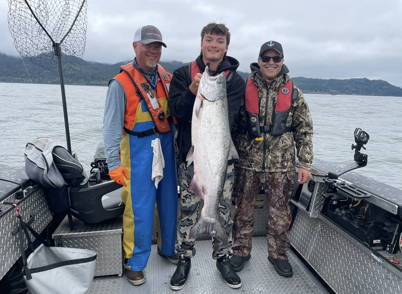 Client holding a chrome Chinook on the Columbia River