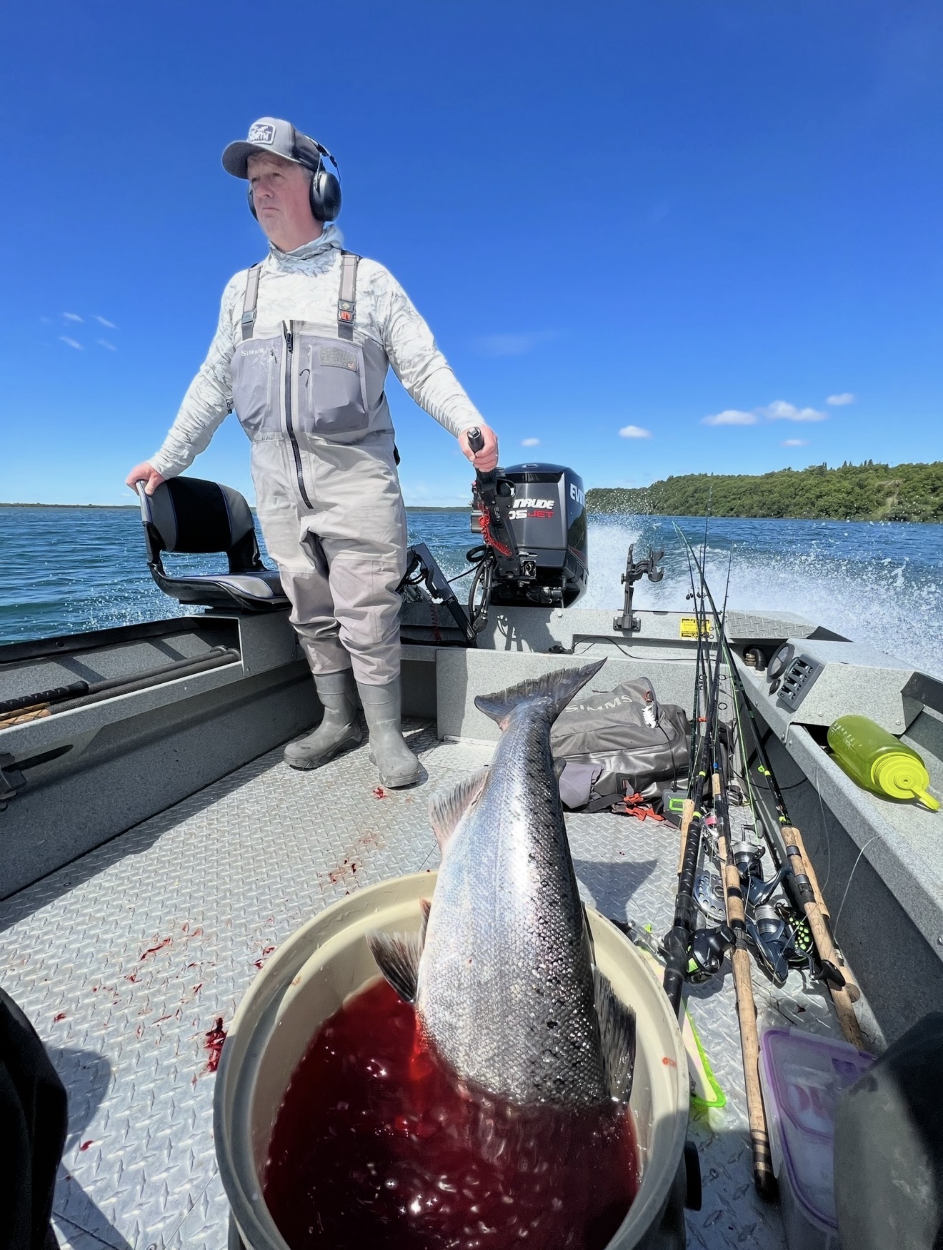 Captain running the jet sled with a bright salmon in the bucket