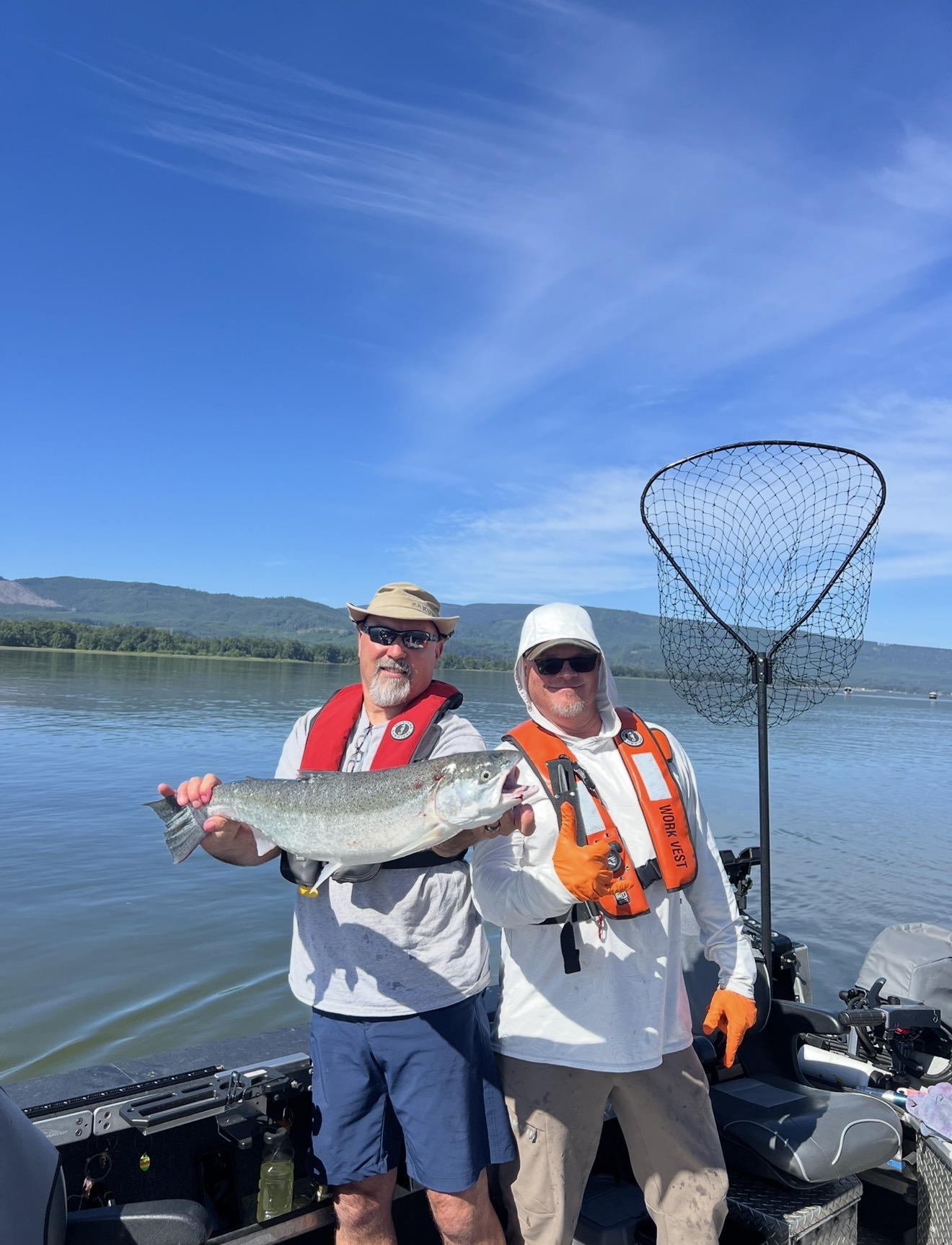 Two clients on the boat with a bright Chinook on a bluebird Columbia day
