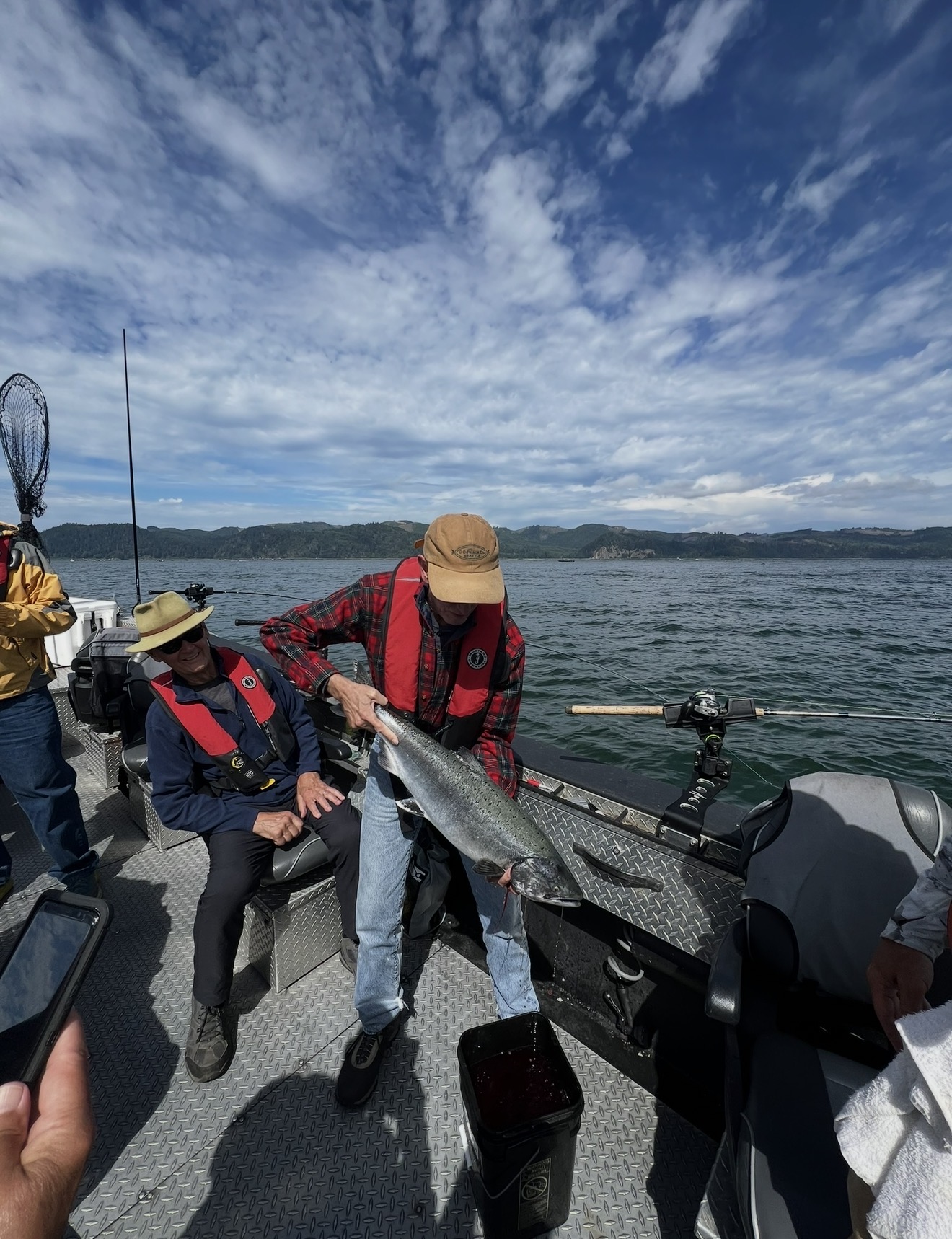 Client on the boat with a Columbia River Chinook on a bluebird day