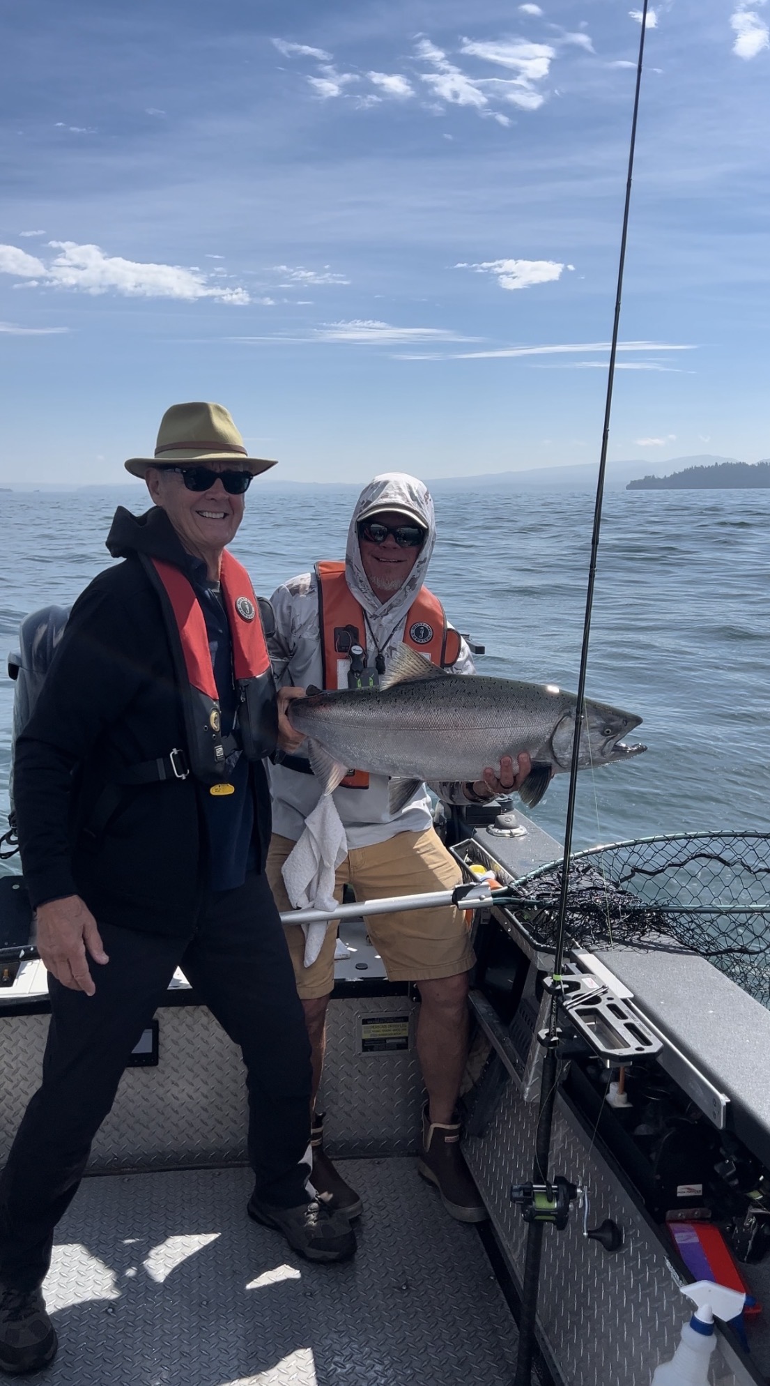 Clients on the boat with an ocean Chinook salmon