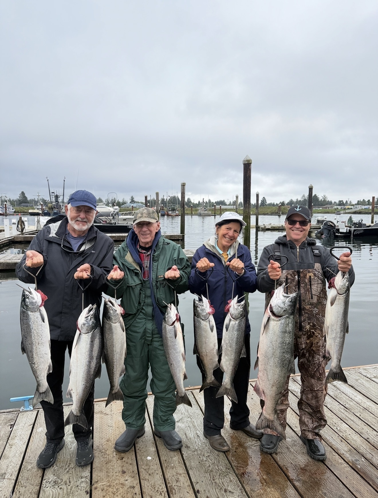 Four clients on the dock with a limit of bright Chinook salmon