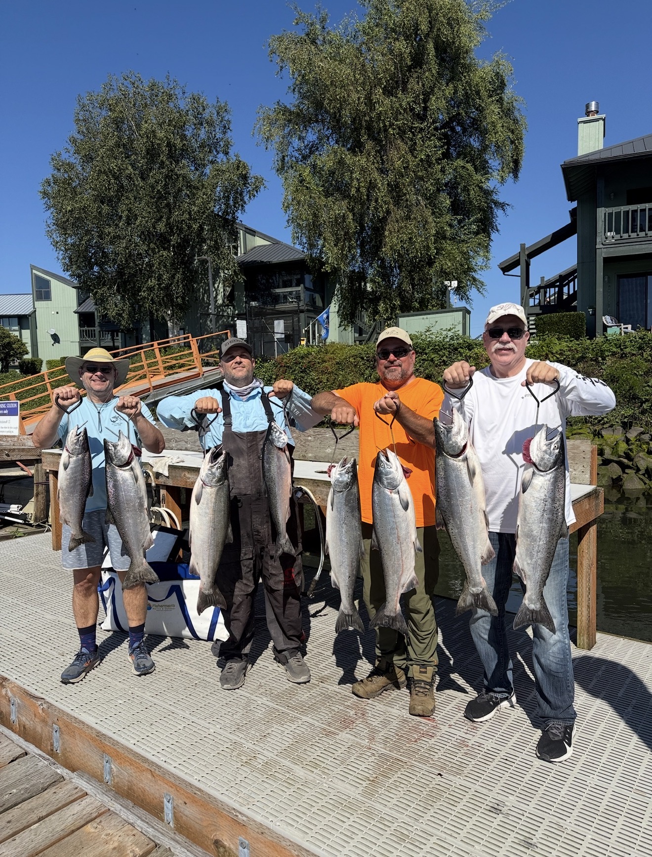 Four clients on the dock holding a limit of bright Chinook salmon