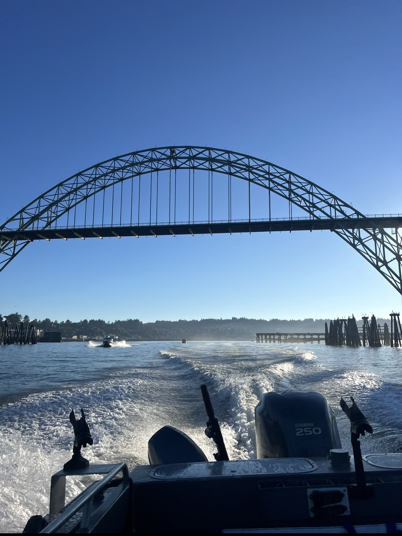 Running under the Yaquina Bay Bridge with wake behind the Yamaha 250